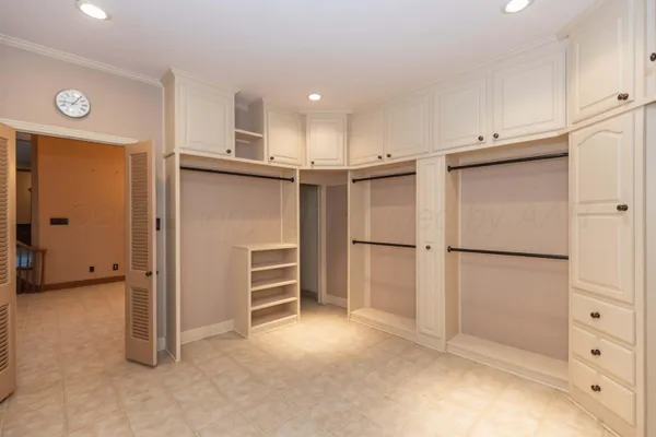 an empty room with a ceiling fan and a window