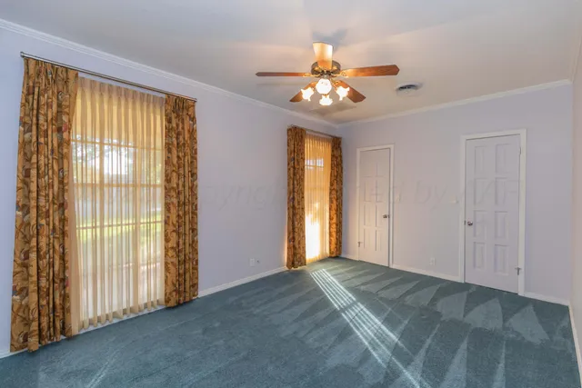 a view of a house with backyard and a tree