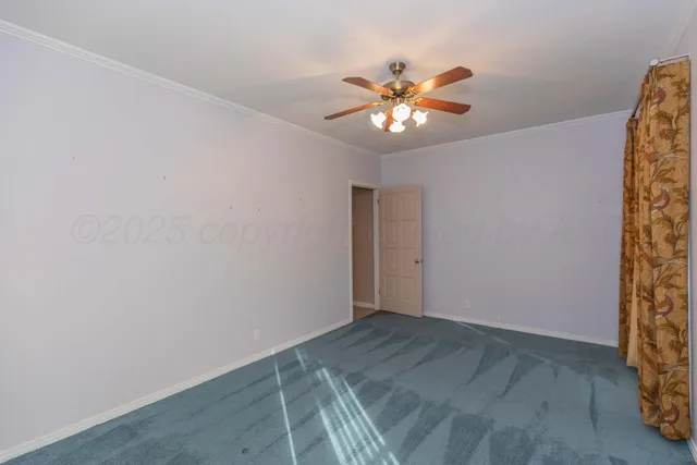 a view of a brick house with plants and large tree