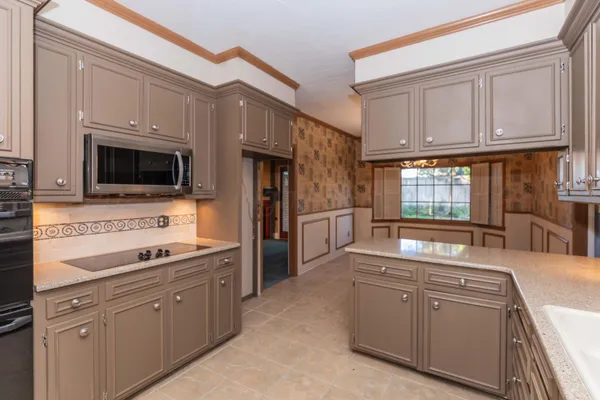 a kitchen with a sink stove and cabinets