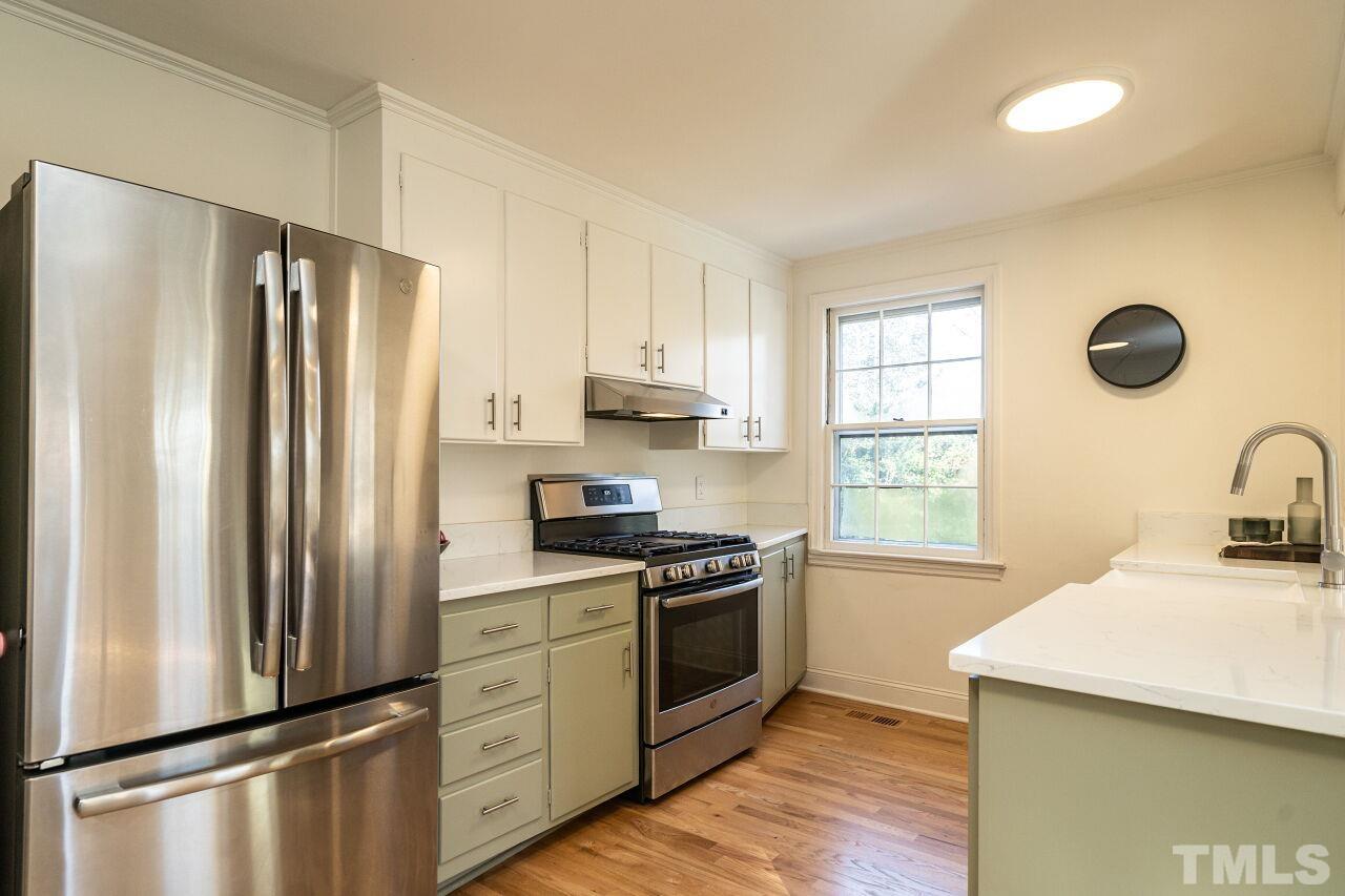 408 North King Charles Road Raleigh, NC 27610 - Photo 8 of 26 a kitchen with stainless steel appliances a refrigerator sink and cabinets