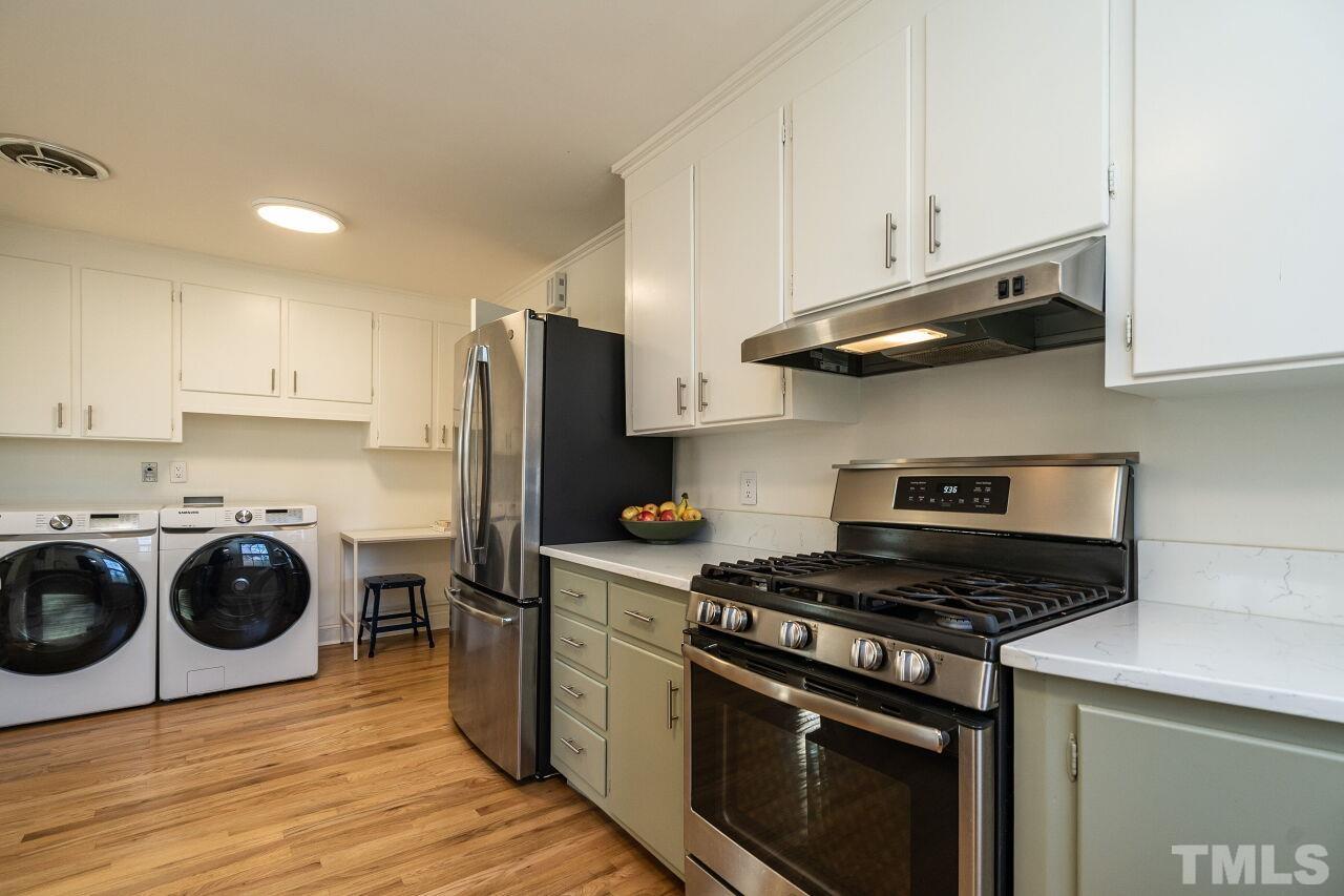 408 North King Charles Road Raleigh, NC 27610 - Photo 10 of 26 a kitchen with a stove and a refrigerator
