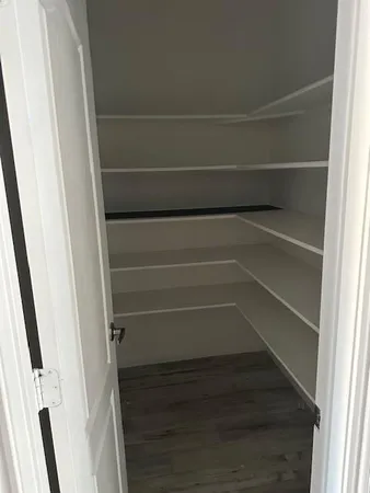 a kitchen with kitchen island granite countertop a sink and a refrigerator