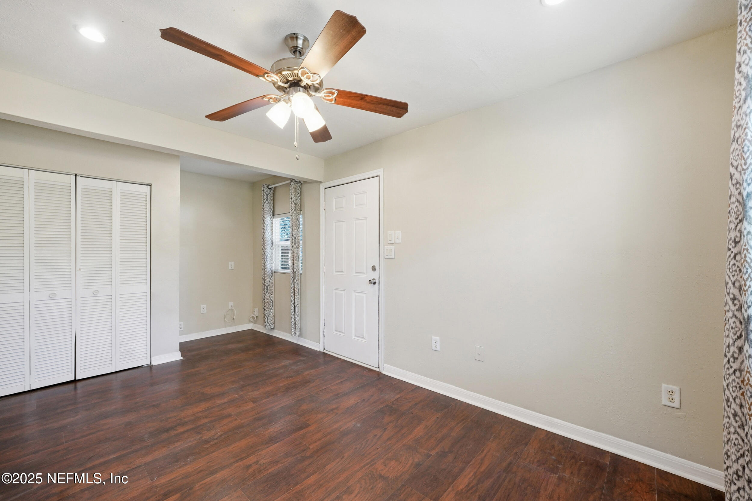 11948 Aaron Road Jacksonville, FL 32218 - Photo 12 of 33 an empty room with wooden floor and ceiling fan