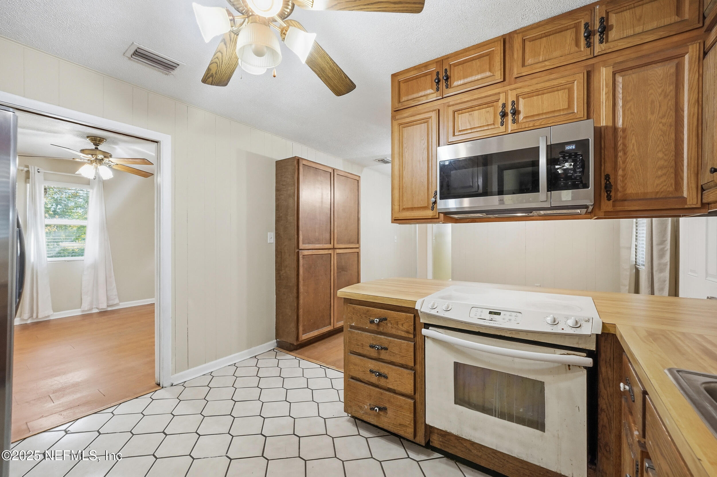 11948 Aaron Road Jacksonville, FL 32218 - Photo 15 of 33 a kitchen with a stove and a microwave