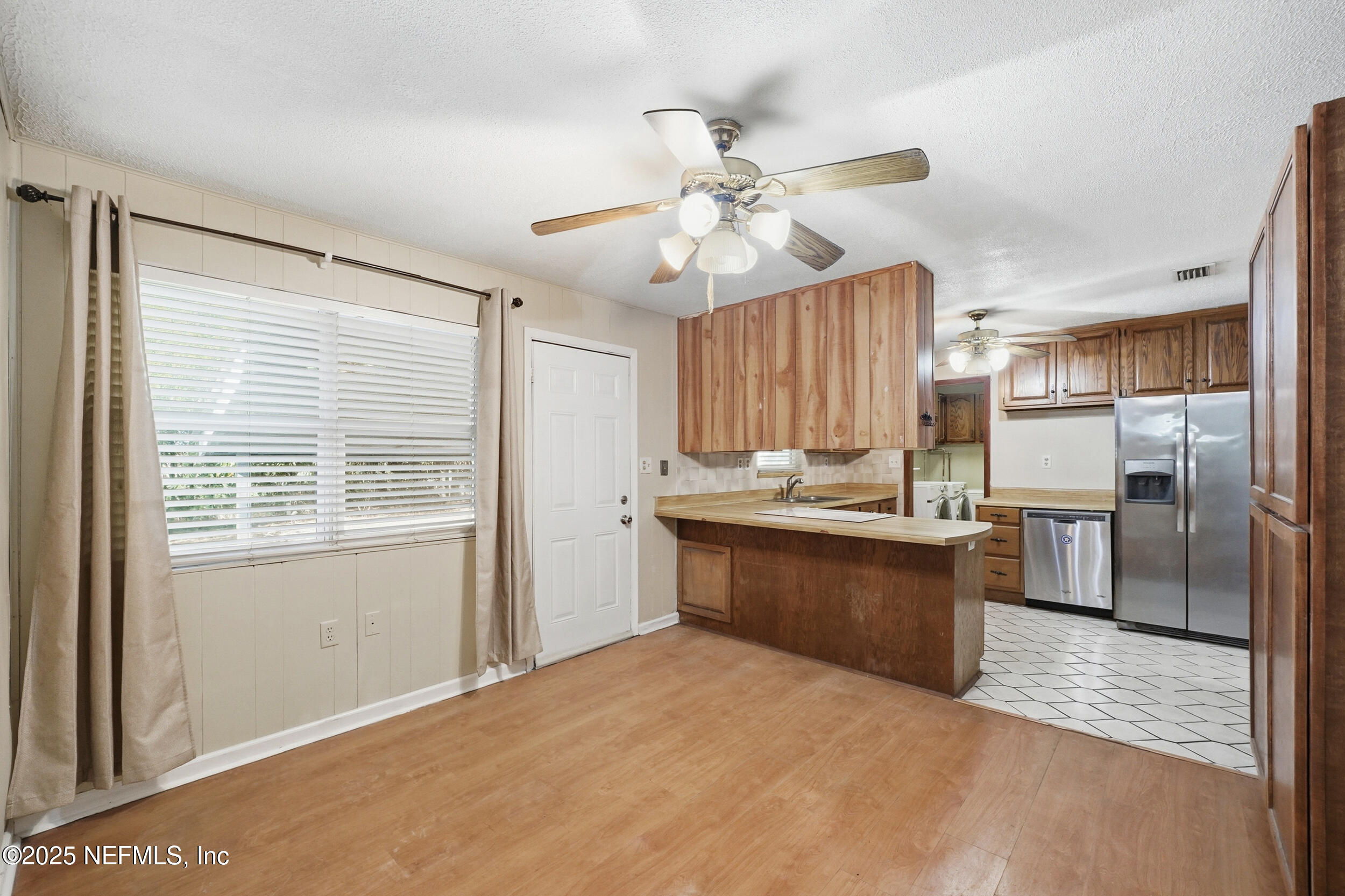 11948 Aaron Road Jacksonville, FL 32218 - Photo 6 of 33 a kitchen with granite countertop stainless steel appliances a refrigerator cabinets and wooden floor