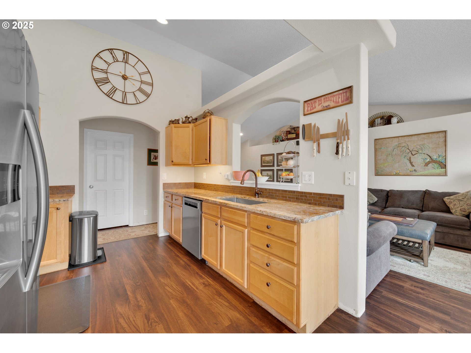 6057 Pebble Court Springfield, OR 97478 - Photo 12 of 42 a kitchen with a refrigerator a sink and a stove with wooden floor