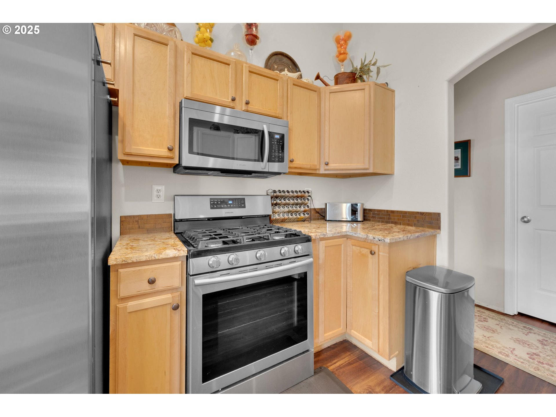 6057 Pebble Court Springfield, OR 97478 - Photo 13 of 42 a kitchen with stainless steel appliances granite countertop a stove a microwave and a refrigerator