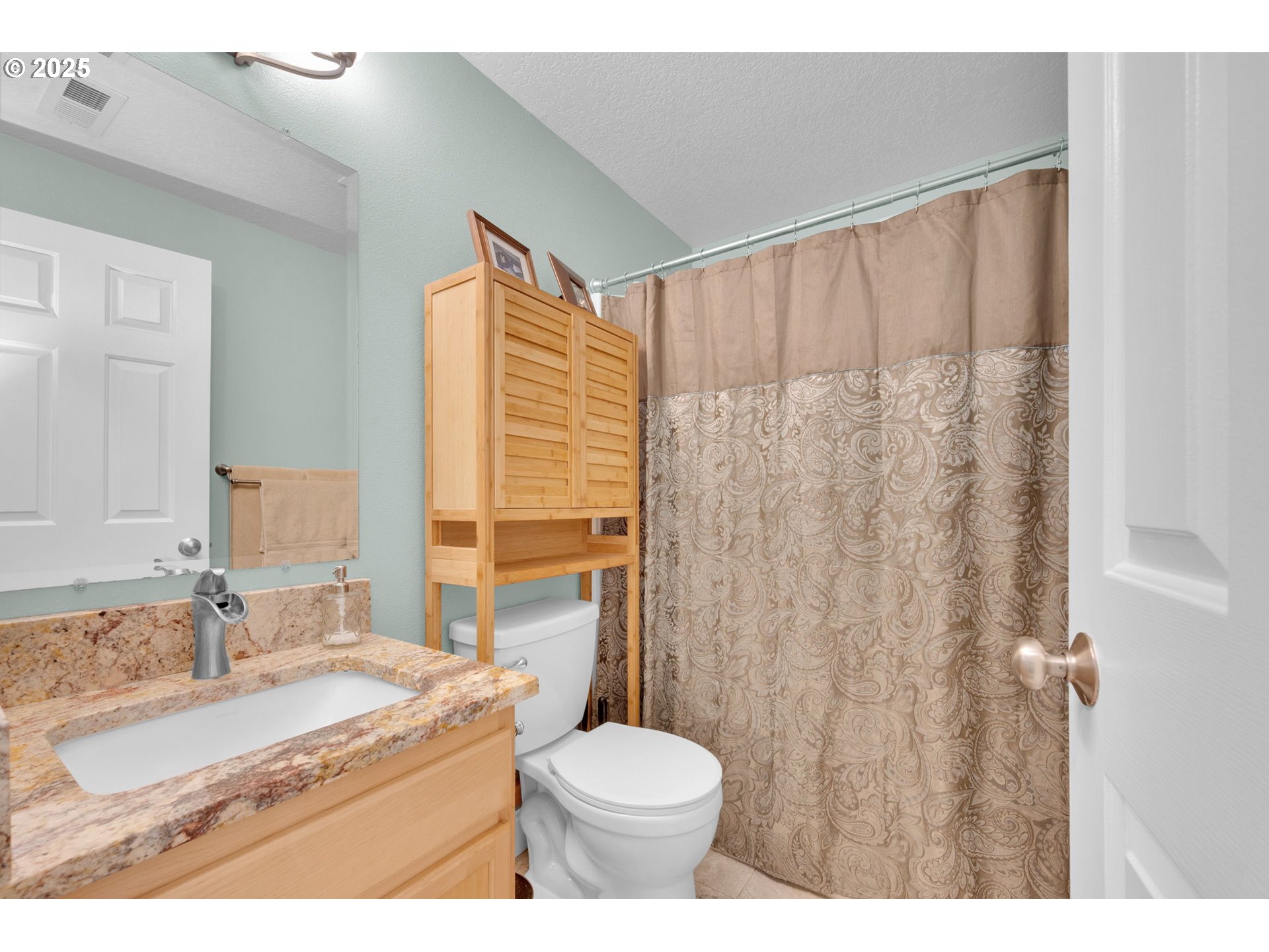 6057 Pebble Court Springfield, OR 97478 - Photo 20 of 42 a bathroom with a granite countertop sink and a mirror