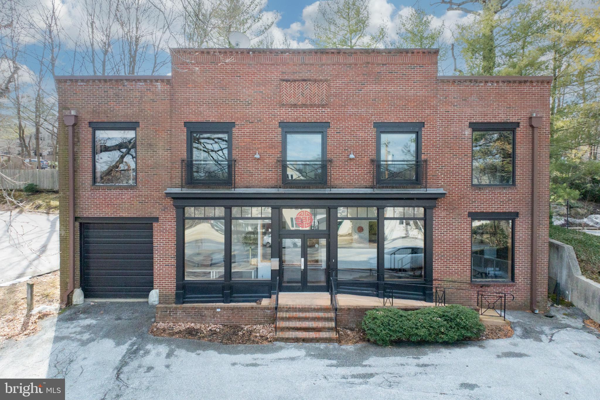 a brick building with a view of front door