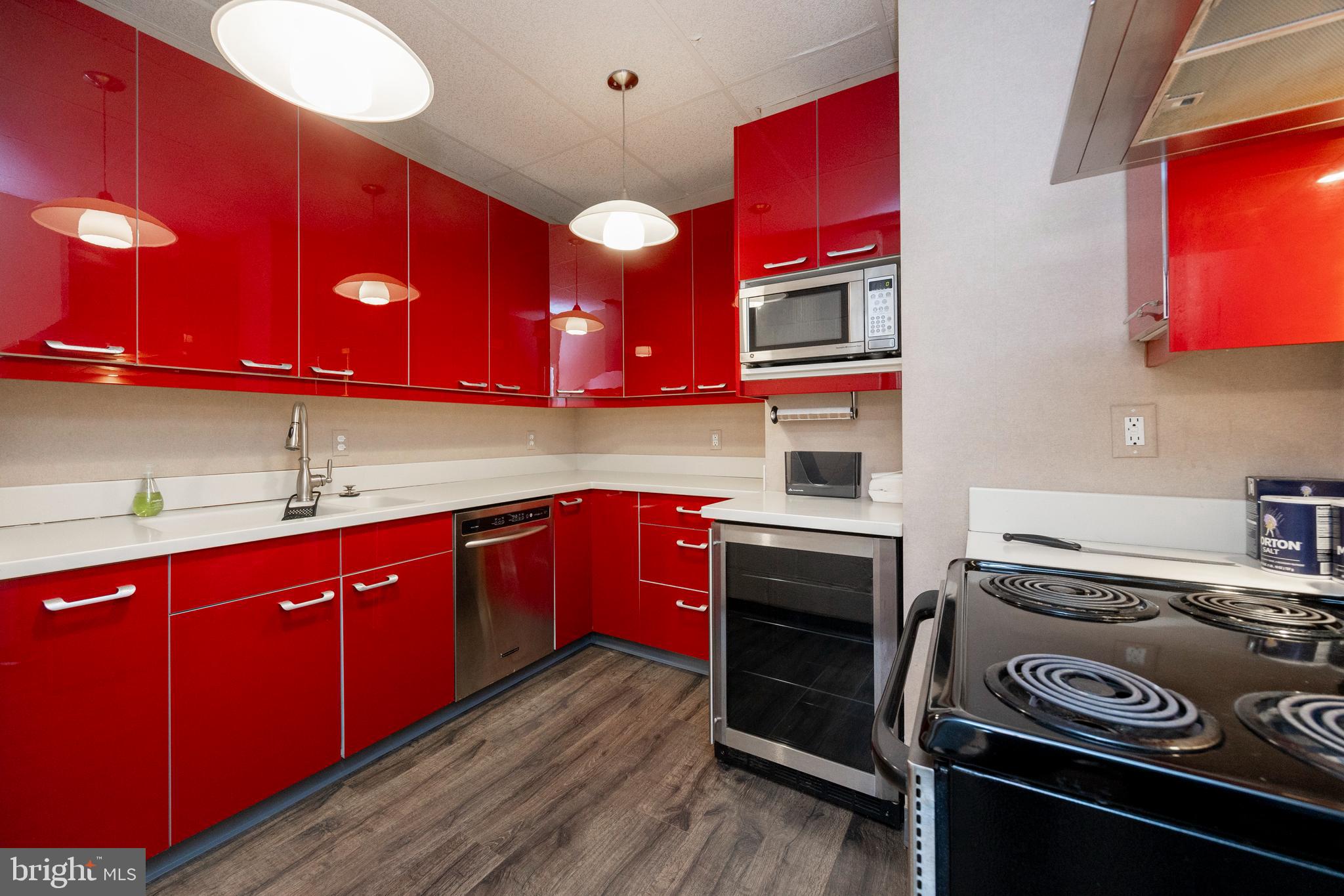 232 Conestoga Road Wayne, PA 19087 - Photo 29 of 34 a kitchen with stainless steel appliances a stove and wooden cabinets