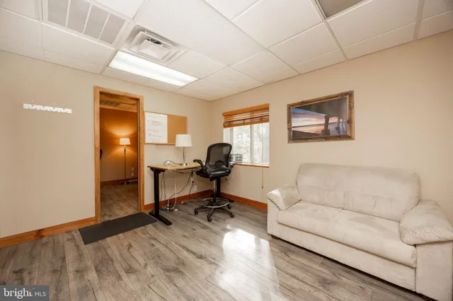 a view of a workspace with furniture and a window