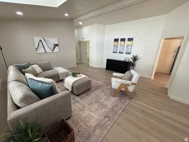 11313 South 265 East Sandy, UT 84070 - Photo 2 of 21 Spacious living area featuring wood-finish flooring and a central area rug