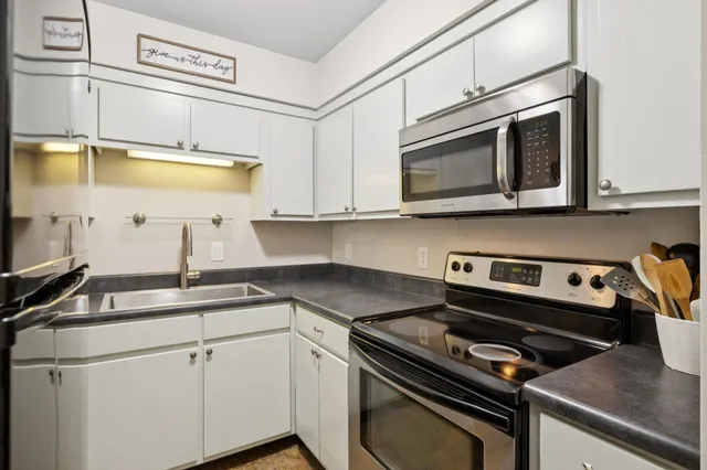 a kitchen with a stove microwave and sink