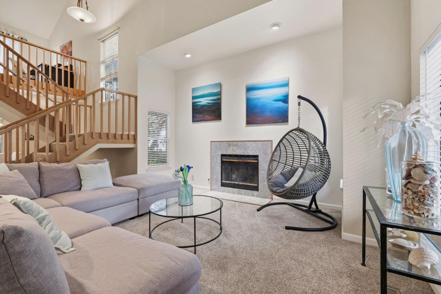 a living room with furniture a fireplace and a chandelier