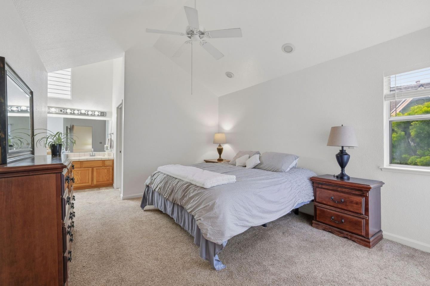 303 Dry Creek Road Aptos, CA 95003 - Photo 22 of 41 a spacious bedroom with a bed and a chandelier