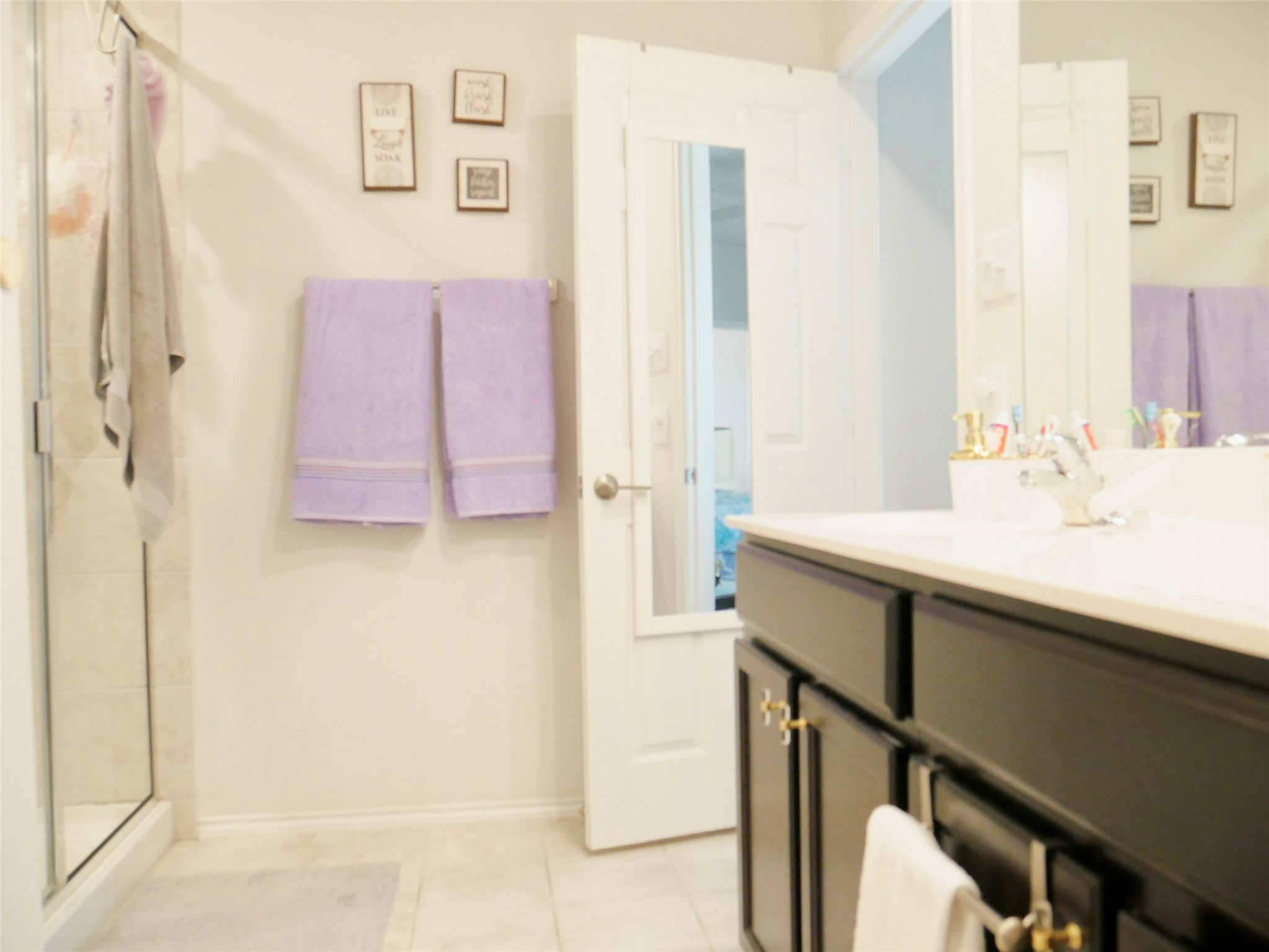 524 Taggart Trail Jarrell, TX 76537 - Photo 12 of 18 a bathroom with a sink a mirror and a shower