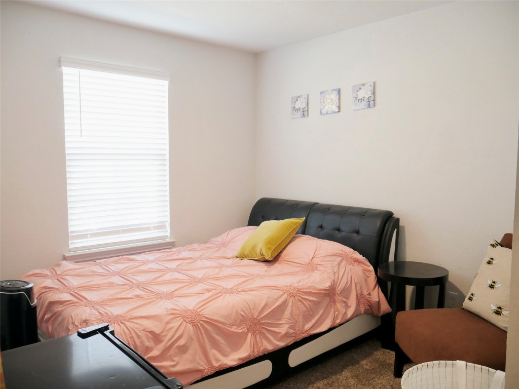 524 Taggart Trail Jarrell, TX 76537 - Photo 16 of 18 a bedroom with a bed and chair