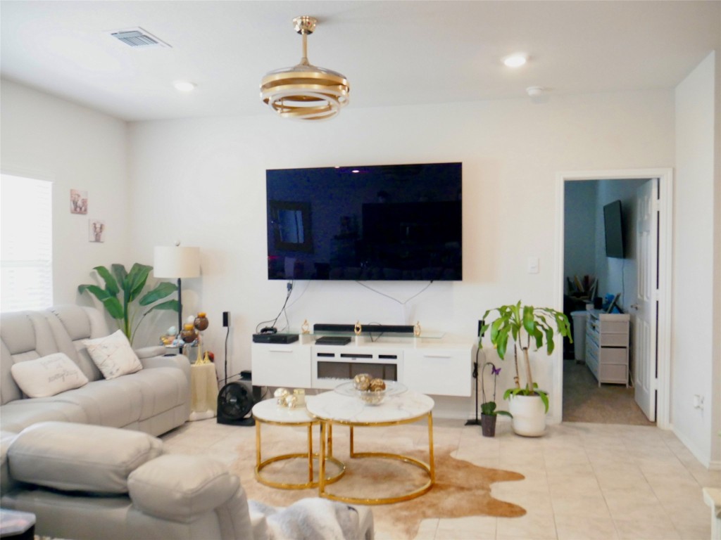 524 Taggart Trail Jarrell, TX 76537 - Photo 6 of 18 a living room with furniture and a flat screen tv
