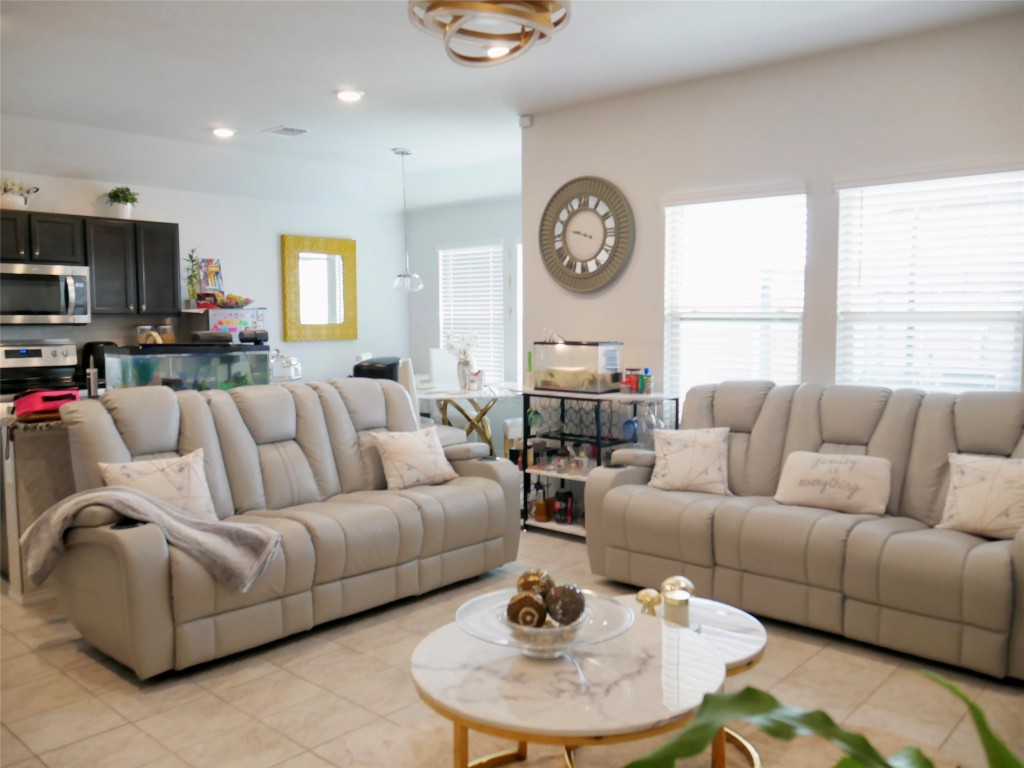 524 Taggart Trail Jarrell, TX 76537 - Photo 7 of 18 a living room with furniture a large window and a clock