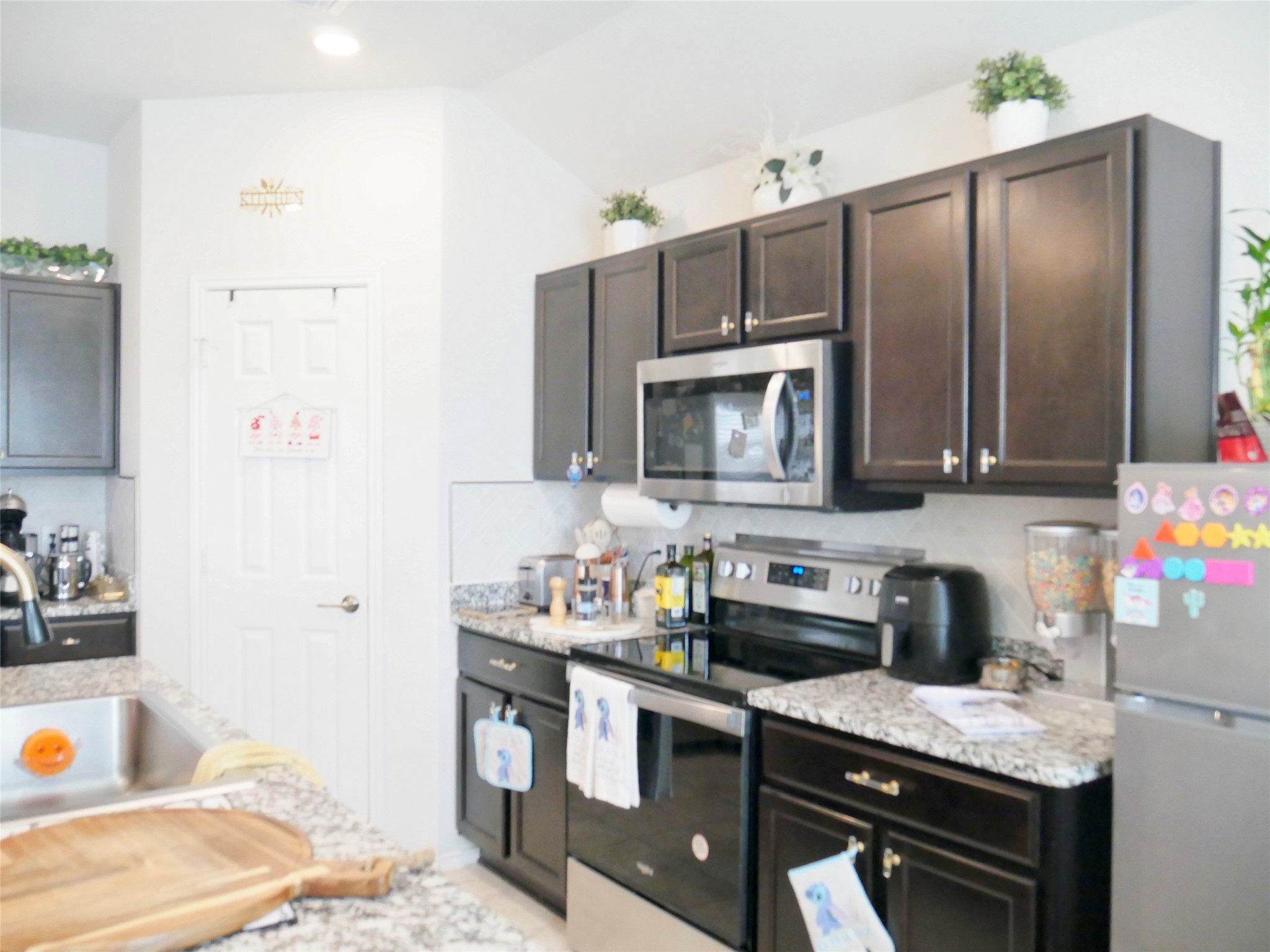 524 Taggart Trail Jarrell, TX 76537 - Photo 8 of 18 a kitchen with a sink appliances and cabinets