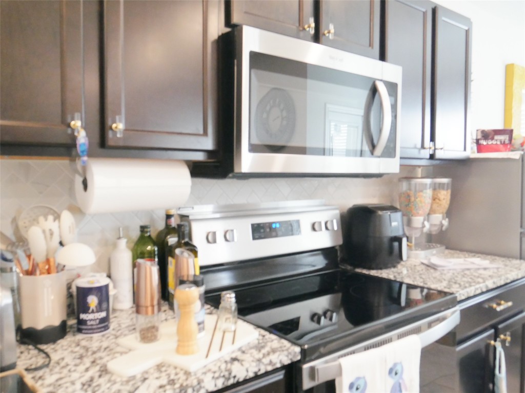 524 Taggart Trail Jarrell, TX 76537 - Photo 9 of 18 a kitchen with a stove and a microwave