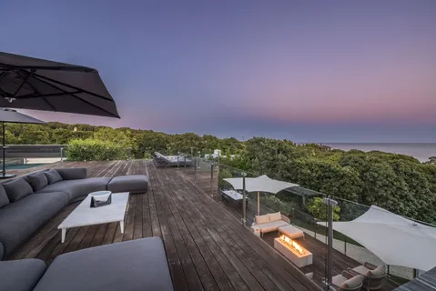 a view of a terrace with couches and pool