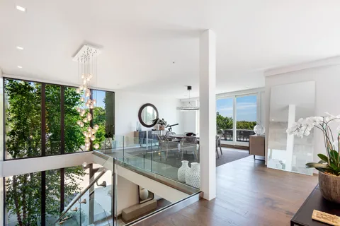 a kitchen with a large window and living room