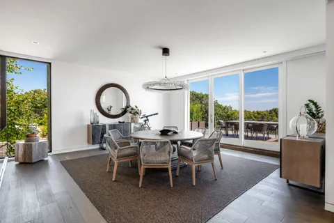 a dining room with furniture window and wooden floor