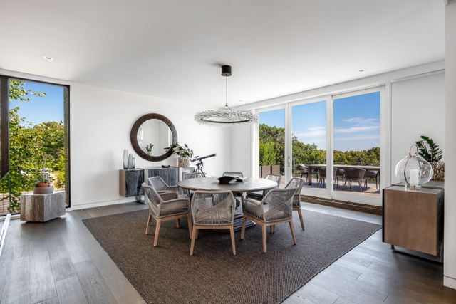 a dining room with furniture window and wooden floor