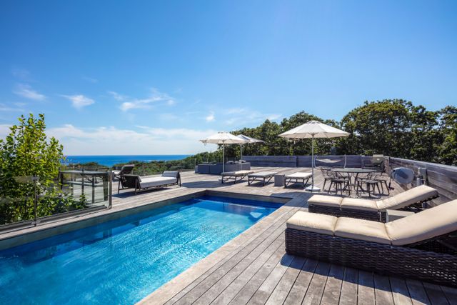 a view of a patio with couches and pool