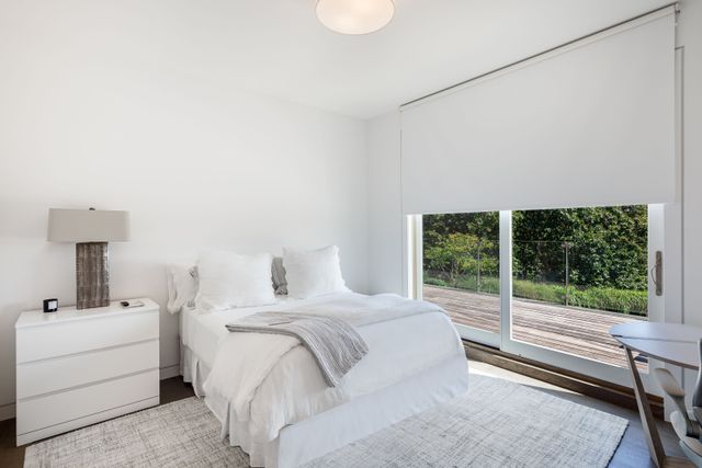 a bedroom with a bed and a large window