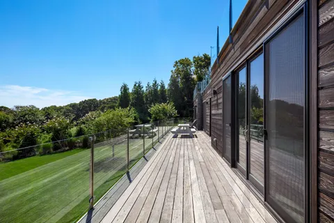 a view of a balcony with yard