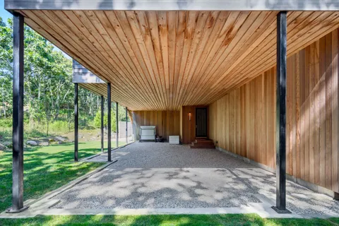 a view of a house with backyard and porch