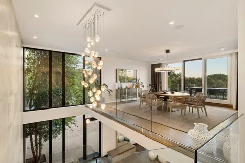 a view of a dining room with furniture large windows and wooden floor