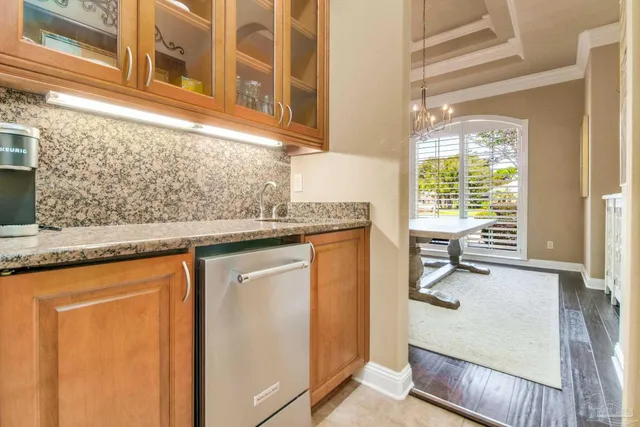 a kitchen with stainless steel appliances kitchen island granite countertop a table and chairs in it