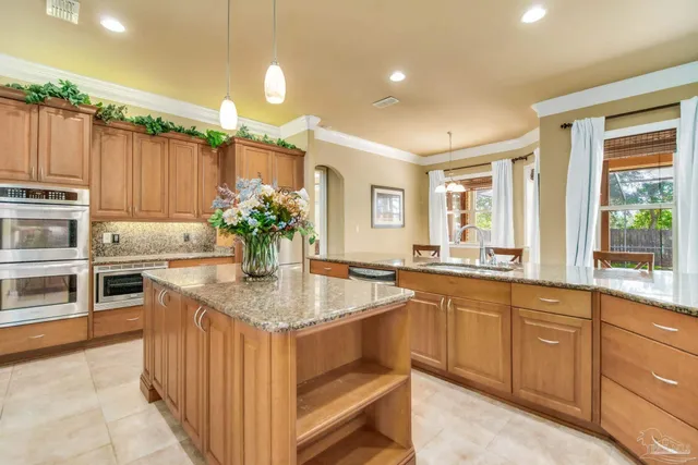 a bathroom with a granite countertop sink a mirror and a shower
