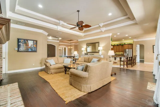 a living room with furniture or chandelier and a wooden floor