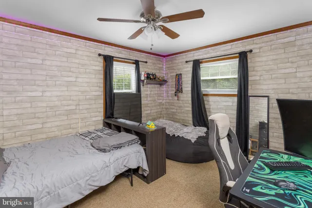a bathroom with a granite countertop sink toilet a mirror and shower