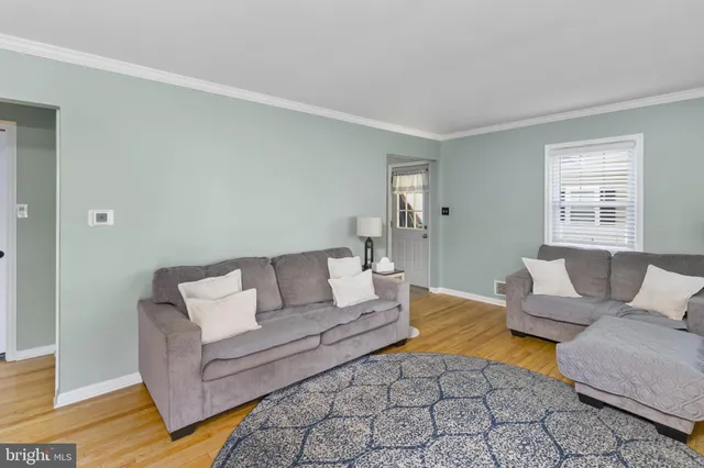 a kitchen with stainless steel appliances granite countertop a refrigerator a stove a sink and a stove with white countertops