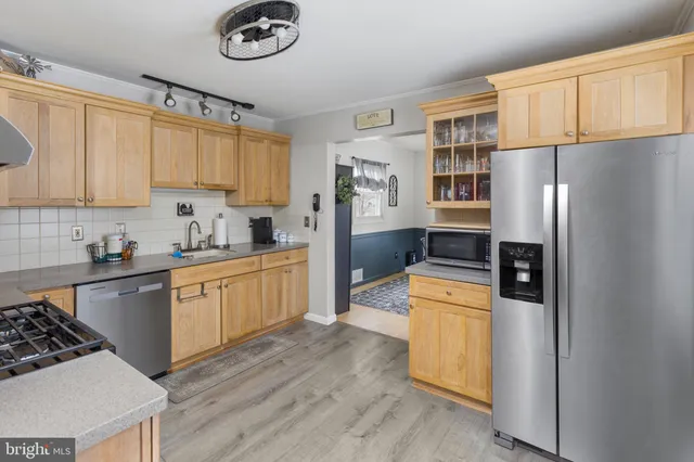 a kitchen with a stove a sink and a window