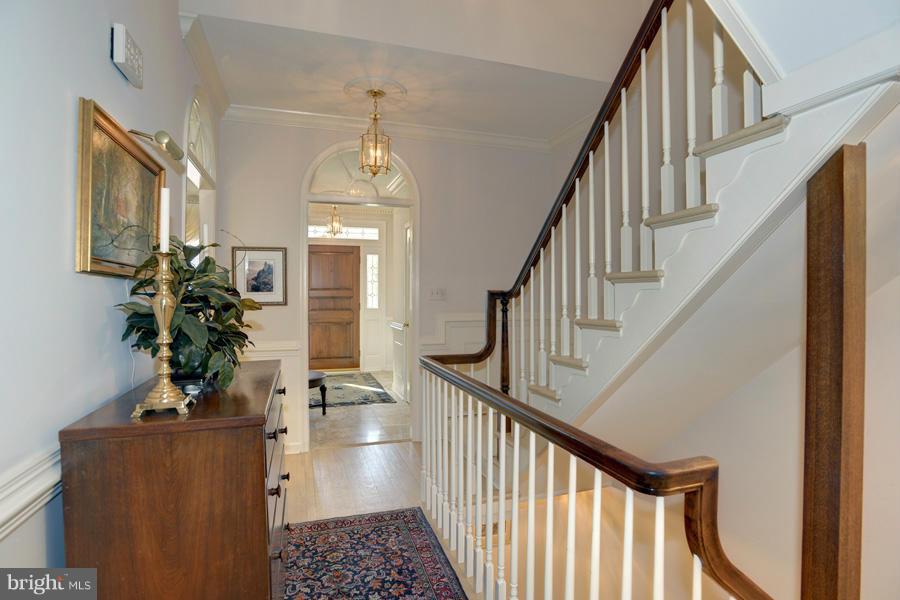 3914 North Glebe Road Arlington, VA 22207 - Photo 2 of 17 a view of hall way with wooden floor and staircase