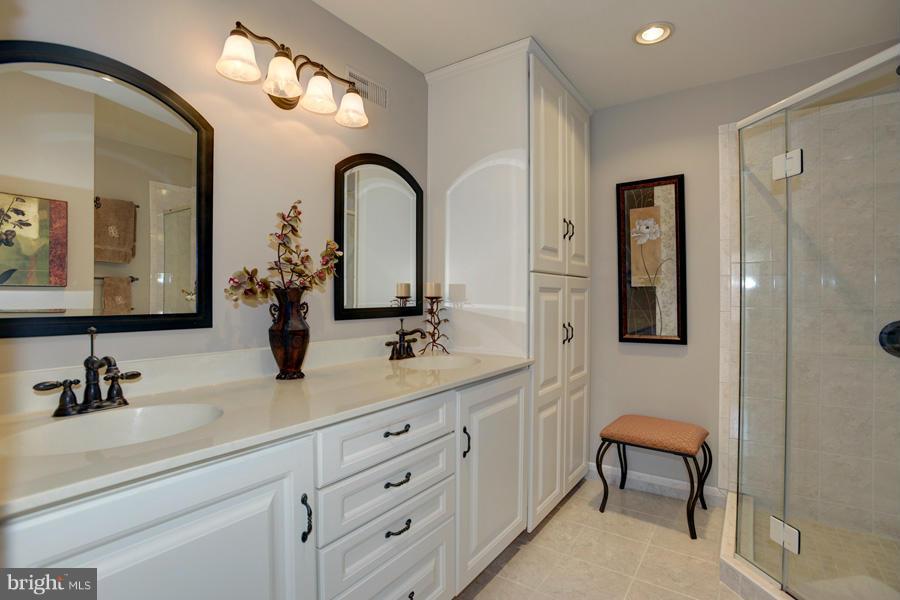 3914 North Glebe Road Arlington, VA 22207 - Photo 11 of 17 a bathroom with a double vanity sink mirror and shower