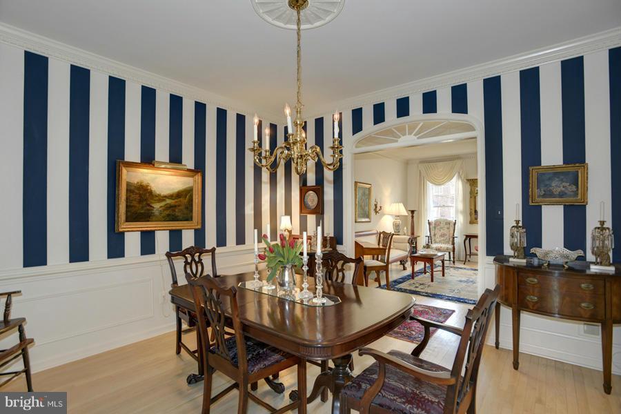 3914 North Glebe Road Arlington, VA 22207 - Photo 6 of 17 a dining room with furniture a rug a potted plant and a chandelier