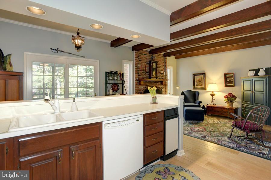3914 North Glebe Road Arlington, VA 22207 - Photo 7 of 17 a large kitchen with stainless steel appliances double vanity sink and a fireplace