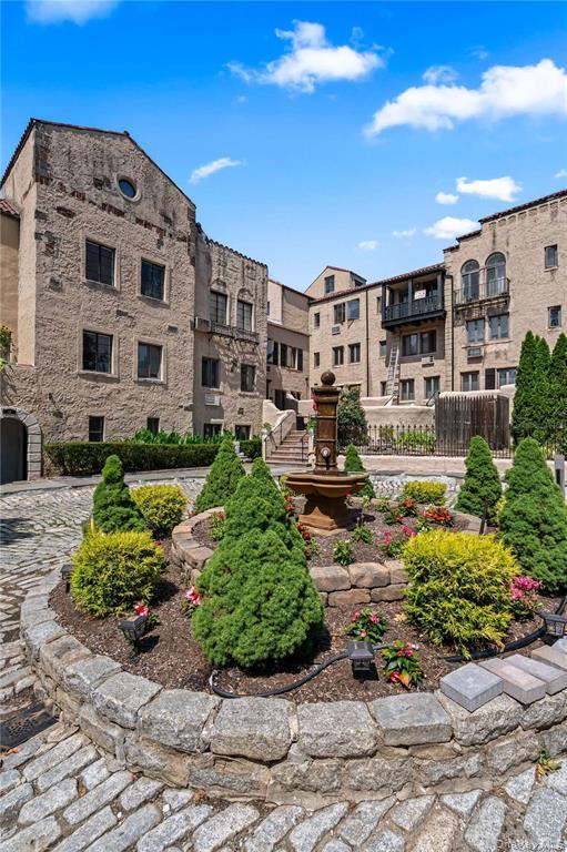 215 Middle Neck Road, Unit 13A Great Neck, NY 11021 - Photo 16 of 20 a view of a building with garden and sitting area