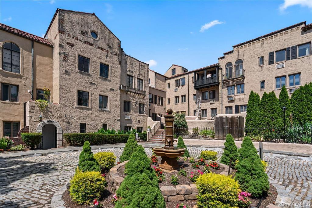 215 Middle Neck Road, Unit 13A Great Neck, NY 11021 - Photo 17 of 20 a front view of a building with garden