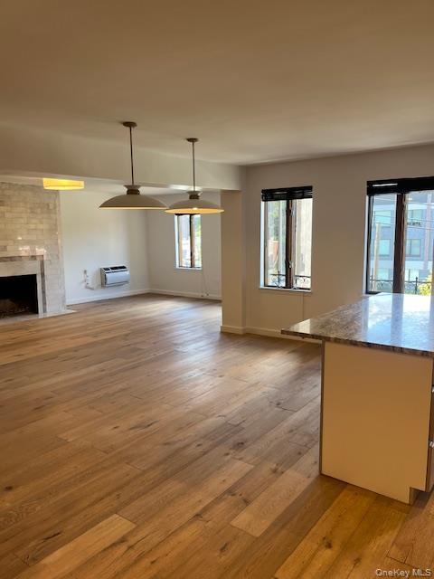 215 Middle Neck Road, Unit 13A Great Neck, NY 11021 - Photo 4 of 20 an empty room with wooden floor and windows