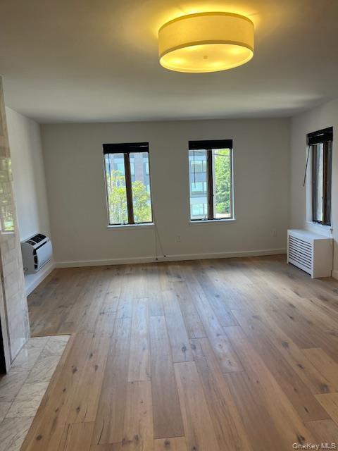215 Middle Neck Road, Unit 13A Great Neck, NY 11021 - Photo 6 of 20 an empty room with wooden floor and windows