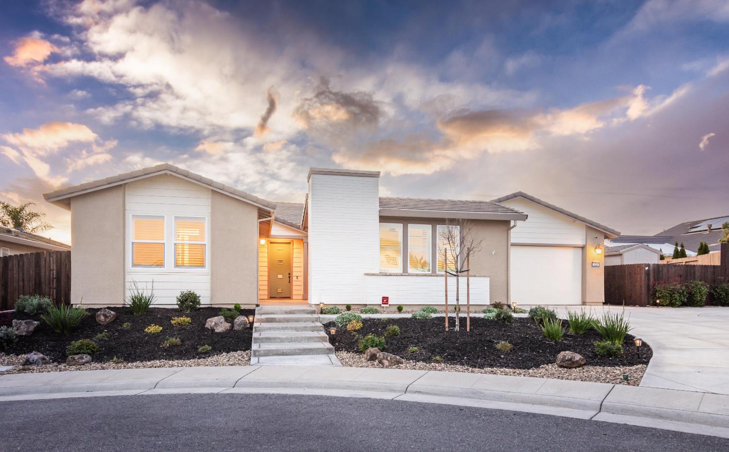 view of front of property with concrete driveway, a garage, and stucco siding